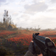A survivor points a gun at a bunch of flowers in a field in STALKER 2 on Xbox.